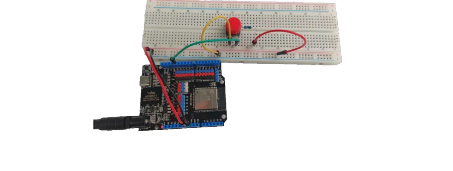 לוח ESP32 מחובר ללוח ניסוי עם לחצן אדום ונגד